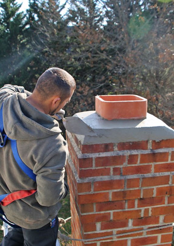 Chimney technician on a rooftop