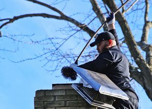 Chimney sweep on a rooftop
