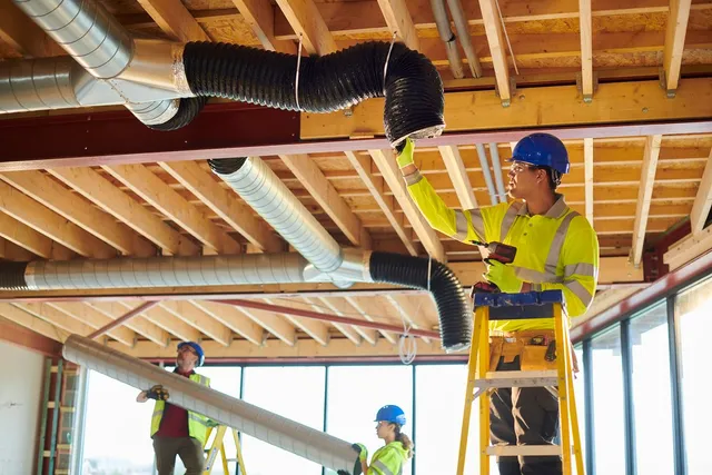Crew installing commercial air ducts