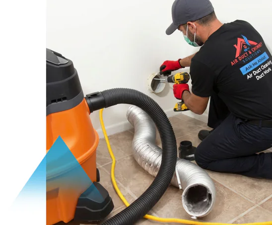 Technician cleaning a dryer vent with a vacuum